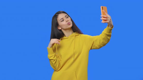 Portrait of Pretty Brunette Making Selfie on Mobile Phone Then Looking Photos / Videohive