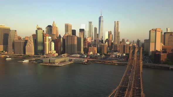 AERIAL: Flight Backwards Over Brooklyn Bridge with Manhattan View Close Up of American Flag at