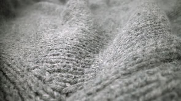 Extreme detail view of sheep wool cloth texture flowing in macro dolly shot.