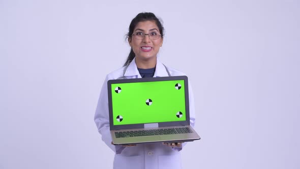 Young Happy Persian Woman Doctor Showing Laptop and Looking Surprised