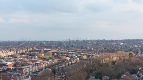 Slider sideways drone shot over suburban north London looking towards city centre