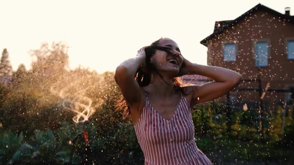 Girl Having Fun and Dancing on the Background of Sunset Rays