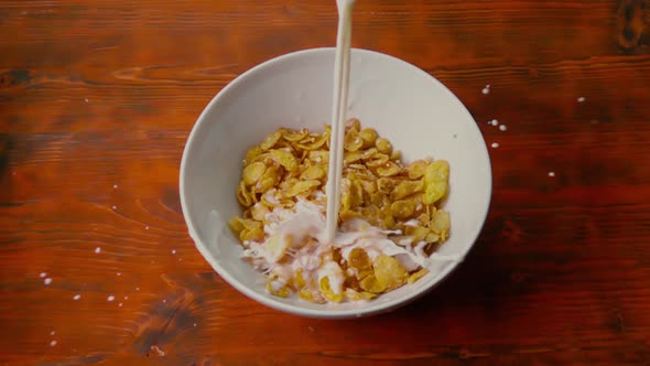 Pouring Milk Into Bowl with Corn Flakes