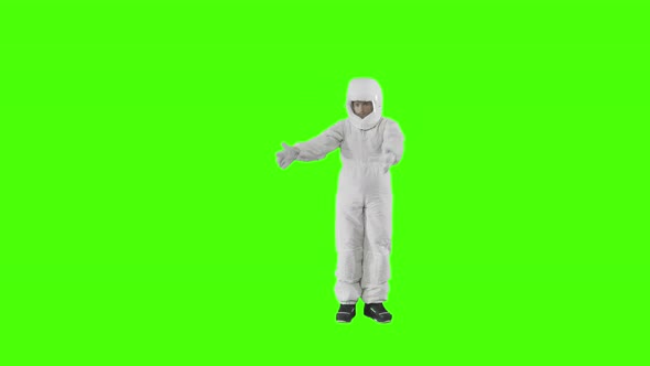 Man in a Spacesuit Stands and Shows with Both Hands in Opposite Directions 