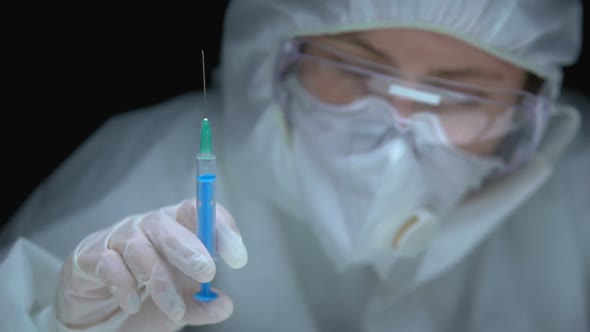 Scientist Holding Syringe With Substance and Test Animal, Developing Medication