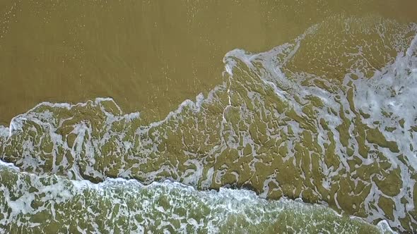 Lace Pattern on the Sand Leave By Waves. Aerial Survey. Slow Motion