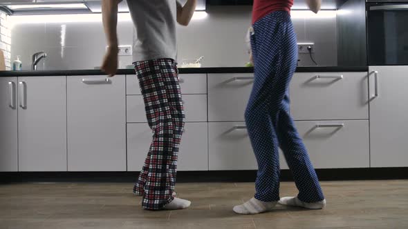 Legs of Happy Couple Dancing in Kitchen
