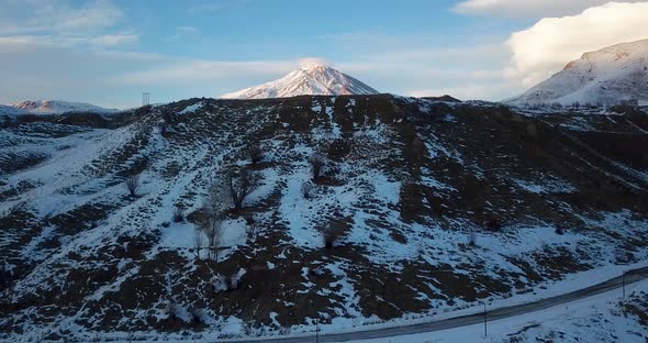 Start Morning Rising Drone Shot In A Cold Sunrise In Winter From A Village Road To Damavand Mountain