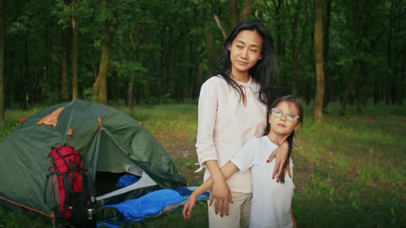 Happy Asian Woman Enjoys Vacation Together with Her Daughter Spends Time in the Forest