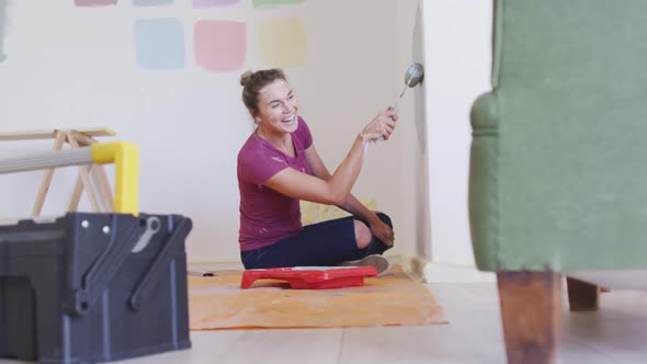 Portrait of a Caucasian woman in quarantine during coronavirus pandemic, doing interior work