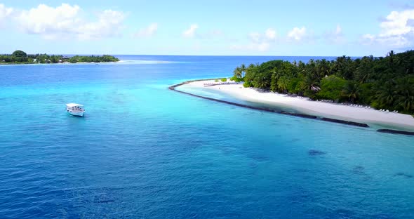 Beautiful overhead island view of a sunshine white sandy paradise beach and blue water background in