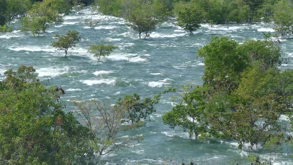 Udawalawe Dam with all four spillways open creating a big stream of water 