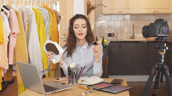 Portrait of a Young Woman Showing the Basics of Makeup on Camera Blogger Leads a Live Broadcast