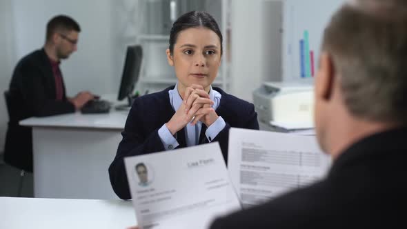 Female Job Candidate Nervously Waiting HR Manager Looking Through Resume