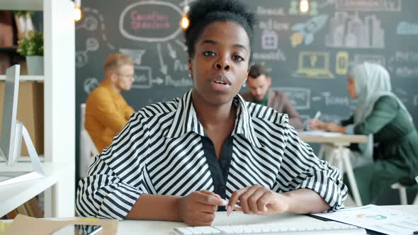 Portrait of Female African American Employee Speaking on Video Call at Work