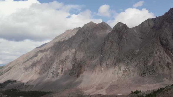 High mountains of Aktru valley with ice and forest