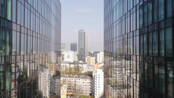 Aerial view mirror building. you can watch the skyscrapers at the background. Drone passing in betwe