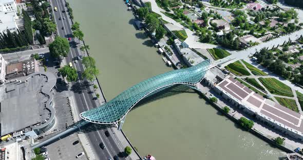 Aerial view of Tbilisi city central park and Bridge of Peace. Beautiful cityscape of old Tbilisi