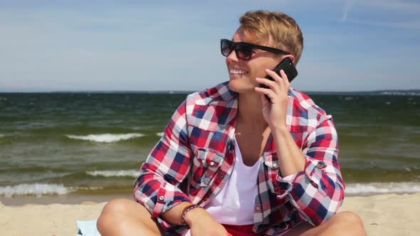 Smiling Man Calling on Smartphone at Summer Beach