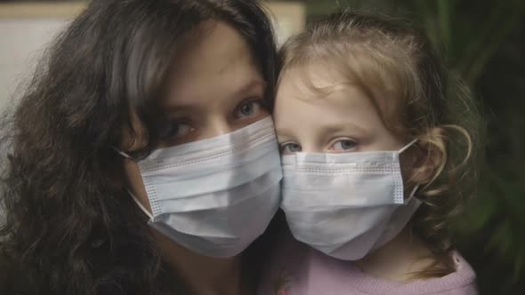 Baby with Mom in a Medical Mask