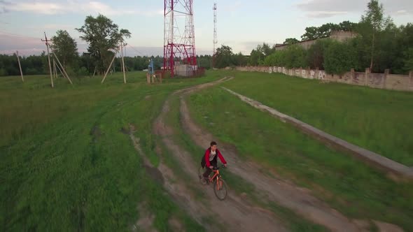 Aerial View of Boy Riding Bike in the Countryside