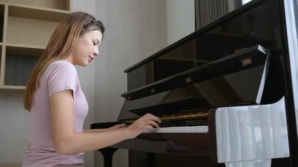 Asian girl who started learning to play the piano.