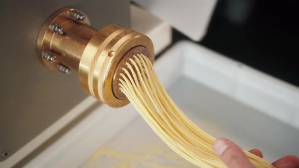 Man Making Fresh Pasta on Traditional Italian Kitchen Machine for Spaghetti Chef Preparing Fresca