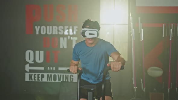 Asian young sport male workout exercise in gym health club using VR fitness and elliptical machine.