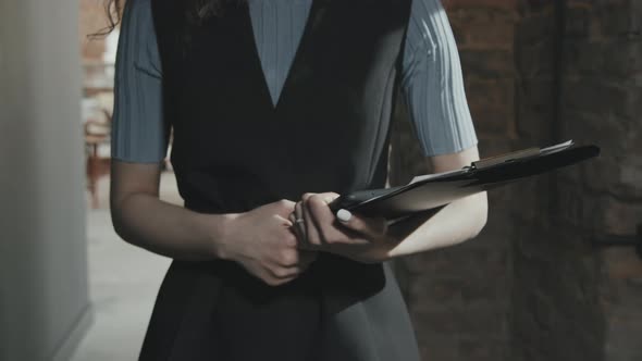 Midsection of Business Woman with Clipboard