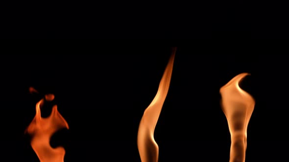 Set of Three Orange Flames in Slow Motion on a Black Background