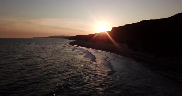 Tropical Beach Video in Sunrise Aerial Bird Eye View of Blue Foaming Ocean Waves Crushing Against