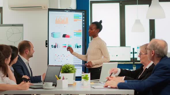 African American Coach Giving Corporate Presentation for Businesspeople