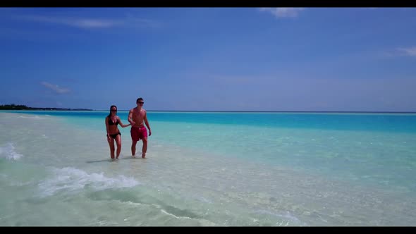 Man and lady in love on luxury bay beach voyage by blue water and white sand background of the Maldi
