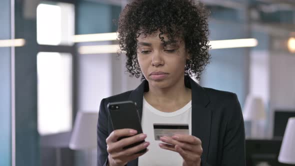 Portrait of Successful African Businesswoman Using Credit Card on Smartphone