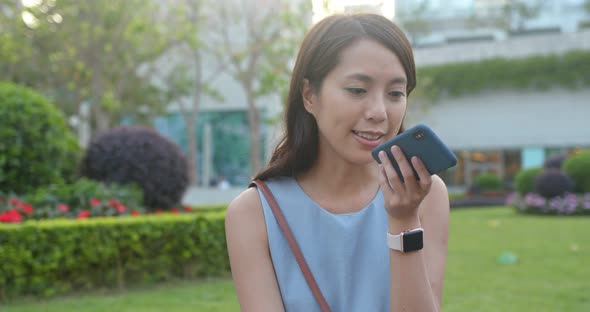 Woman look at the cellphone in the park