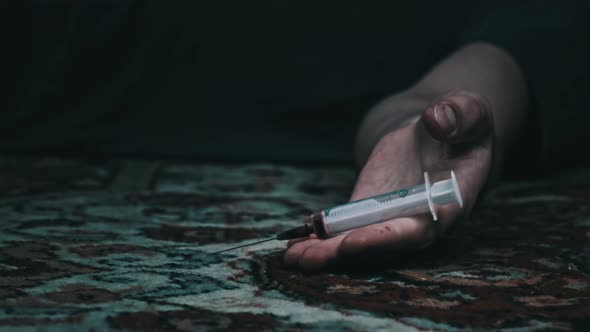 Overdose Addict's Hand Falls to the Floor Drug Syringe Falls Out of It