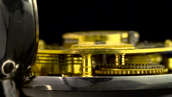 Working Mechanism of the Clock Gear Closeup Rotate . Black Background. Close Up . Sound