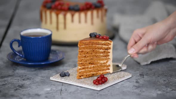 Piece of Layer Caramel Cake with Cream and Fresh Berries