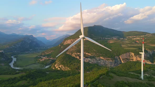 Renewable energy wind turbines at sunset