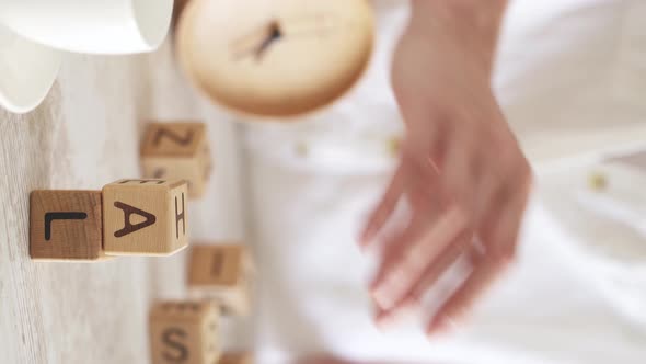 Female Hand Collects The Word Target On The Table. Motivational Word Made From Cubes Hand Makes Goal