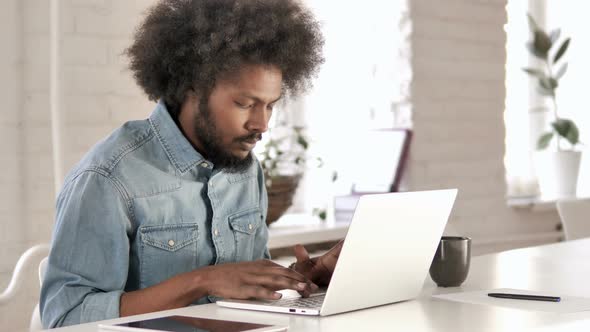 Creative African Man Working On Laptop