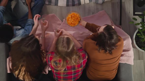 Man Treats Women with Chips Watching TV Series Together