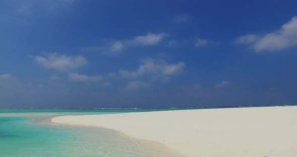 Wide angle overhead clean view of a sandy white paradise beach and blue ocean background in best qua