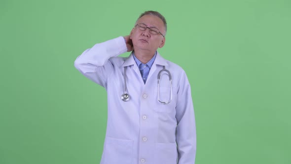 Stressed Mature Japanese Man Doctor Having Neck Pain