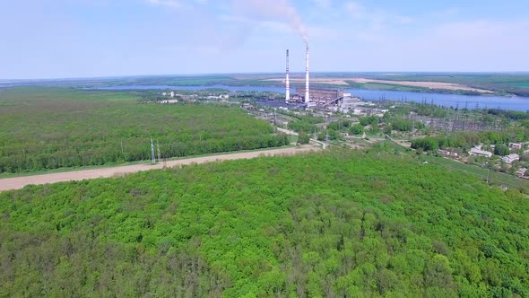Power station with pipes. Aerial view of smoke and steam from high chimney of power plant
