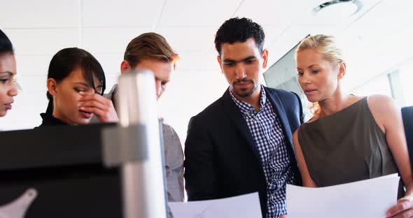 Executives discussing over a document