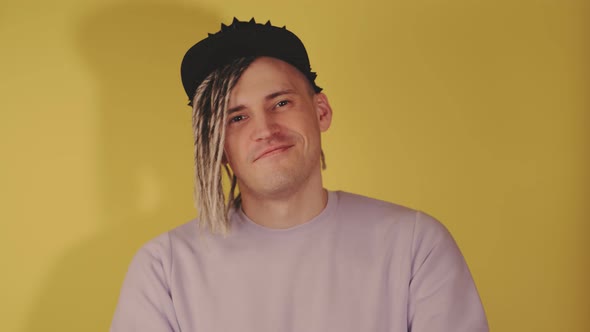 Young Handsome Smiling Man in Black Cap Looking at Camera Applauding with Hands