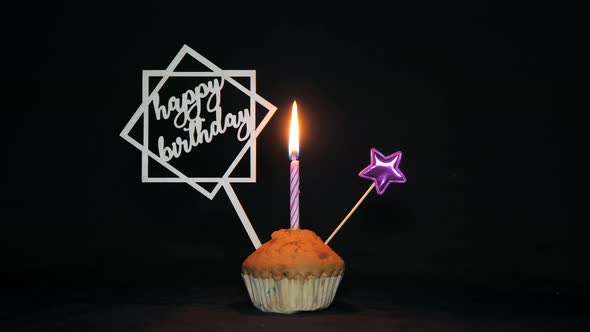 Festive Cupcake with a Candle on a Black Background  Happy Birthday