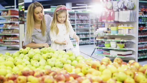 Woman and Daughter Picking Apples