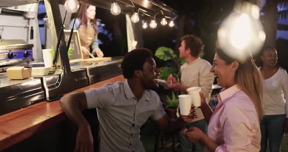 Multiracial people talking in front of food truck outdoor